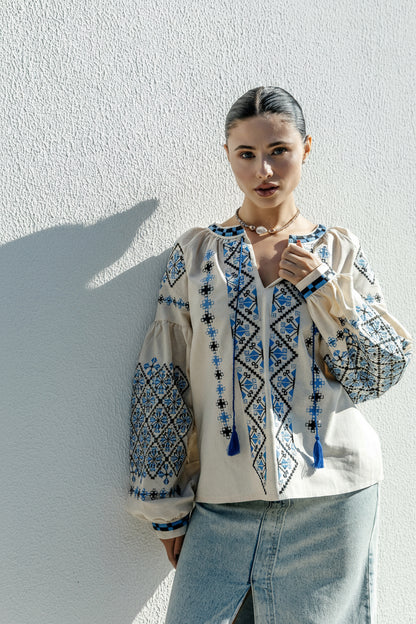 Blouse “Dyvotsvit” – Beige Linen Embroidered Blouse with Blue and Black Patterns and Tassels | Goya Concept